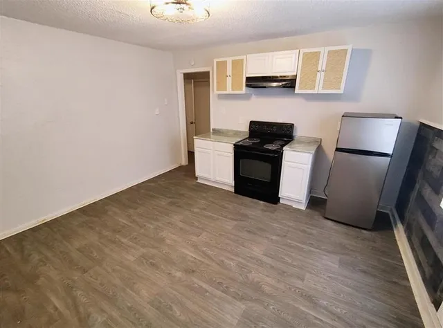 a kitchen with stainless steel appliances a refrigerator and a stove top oven
