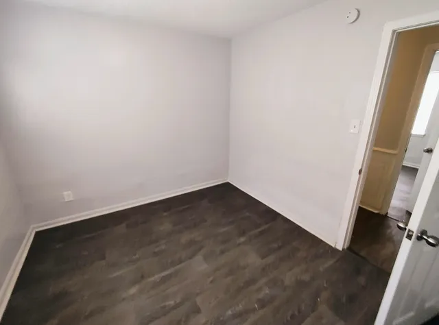 an empty room with wooden floor