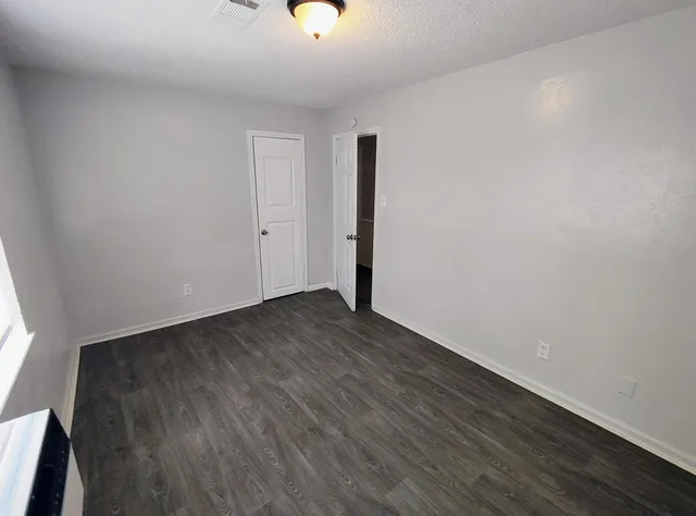 a view of a room with wooden floor