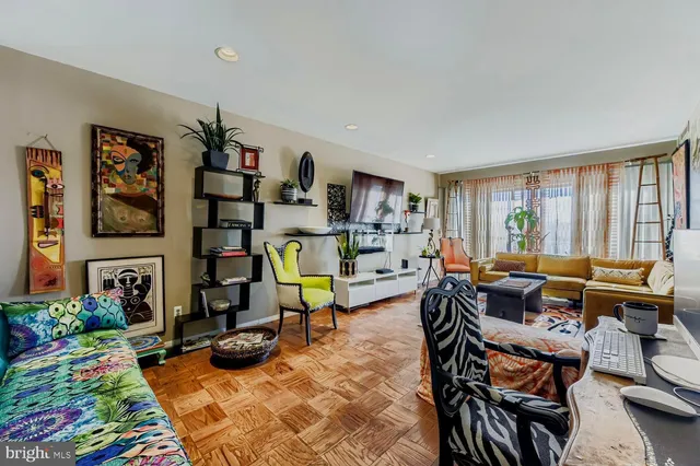a living room with furniture a rug and a large window