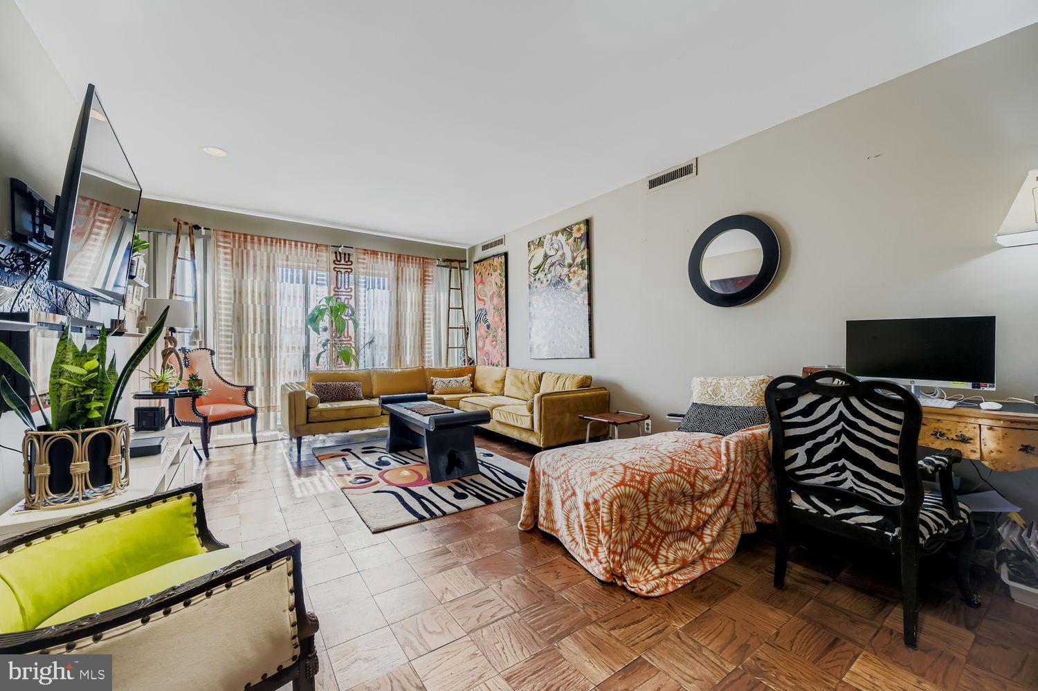 3601 Clarks Lane, Unit 508 Baltimore, MD 21215 - Photo 12 of 24 a living room with furniture a flat screen tv and a window