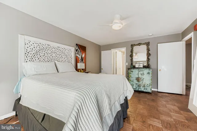 a bedroom with a large bed and a potted plant