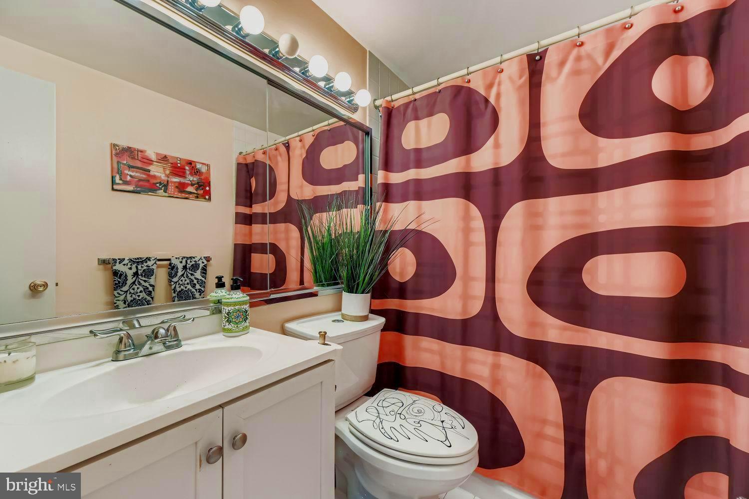 3601 Clarks Lane, Unit 508 Baltimore, MD 21215 - Photo 24 of 24 a bathroom with a sink mirror vanity and toilet