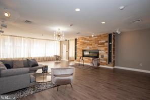 3601 Clarks Lane, Unit 508 Baltimore, MD 21215 - Photo 6 of 24 a living room with fireplace furniture and a large window