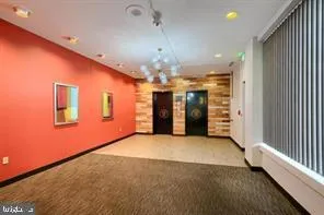 a view of a livingroom with a chandelier furniture and windows