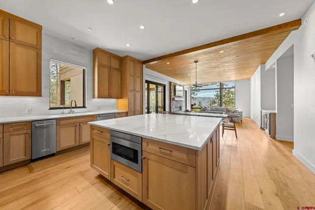 a kitchen with a stove and a wooden floors