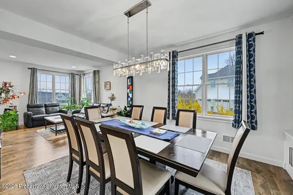 a kitchen with stainless steel appliances kitchen island granite countertop a sink stove and refrigerator
