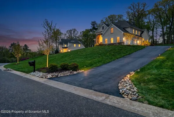 a front view of a house with a yard and outdoor seating