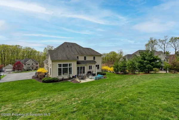 a front view of a house with a big yard