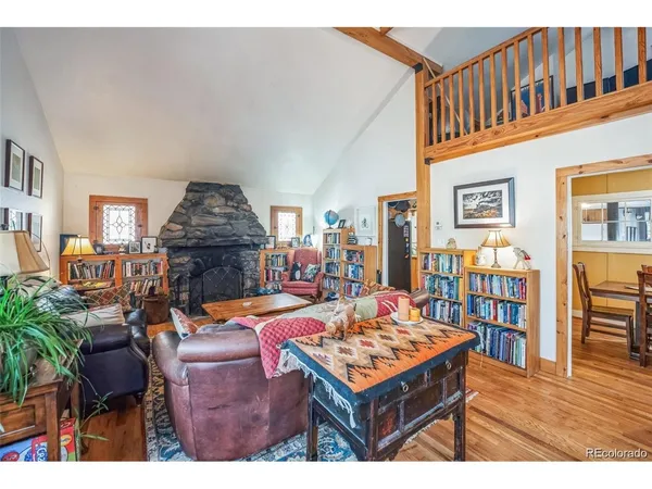 a kitchen with stainless steel appliances granite countertop a stove a sink and a refrigerator with wooden floor