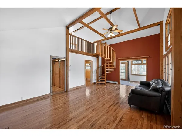 a kitchen with stainless steel appliances granite countertop a refrigerator a sink dishwasher and wooden cabinets with wooden floor