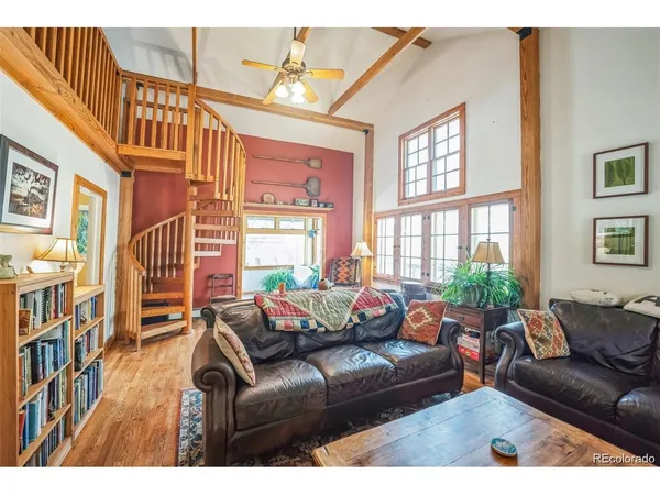 a view of a dining room with furniture a chandelier and wooden floor