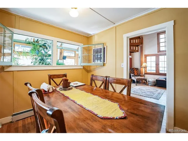 a living room with lots of furniture and a book shelf