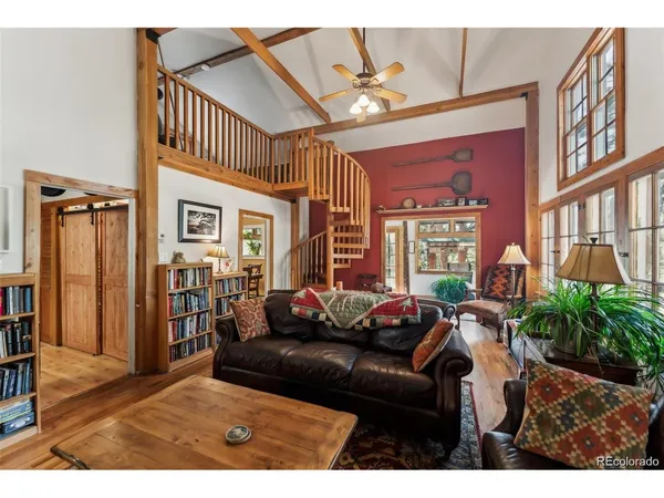 a living room with furniture fireplace and a window