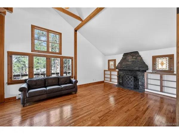 a dining room with furniture and wooden floor