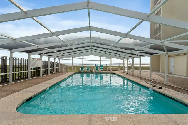 a view of a swimming pool with a yard