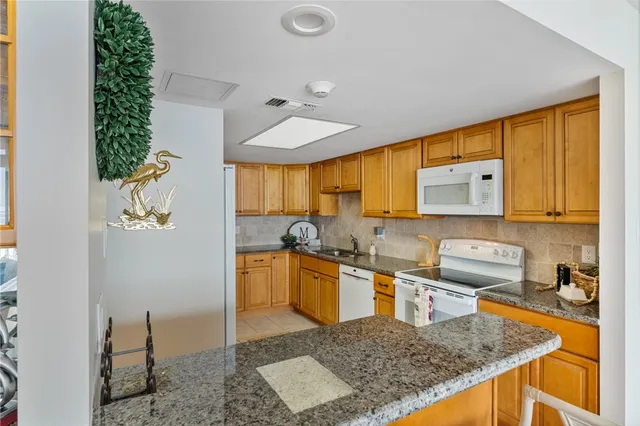 a kitchen with stainless steel appliances granite countertop sink and cabinets