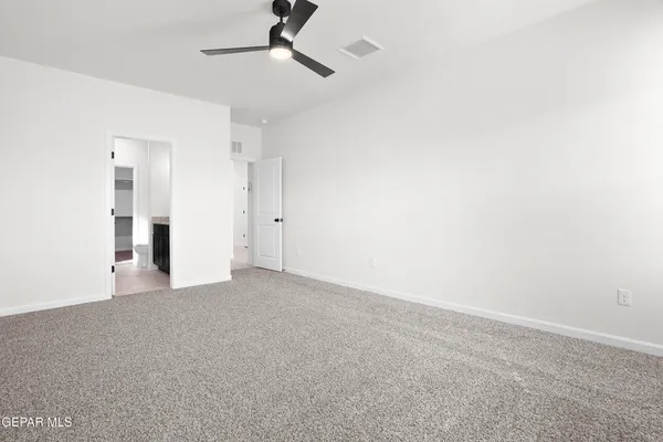 a view of empty room with ceiling fan