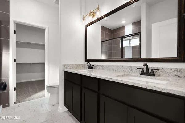 a bathroom with a double vanity sink and a mirror