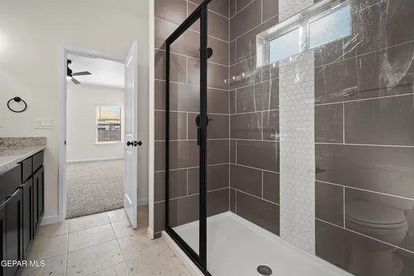 a bathroom with a shower and a mirror