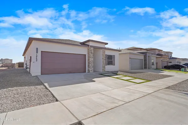 a view of a house with a yard and garage