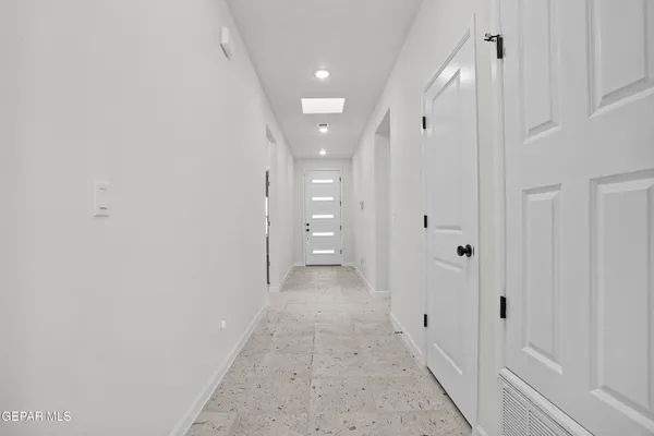 a view of a hallway with wooden shelves