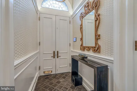 a bathroom with a granite countertop sink a mirror and a bathtub