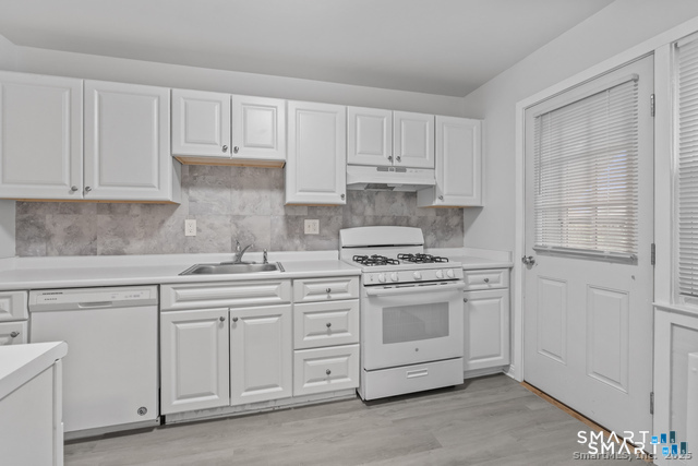 12 Hamilton Court, Unit D Stamford, CT 06902 - Photo 1 of 1 a kitchen with white cabinets and white appliances