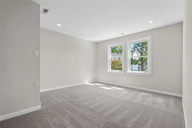 an empty room with windows and closet