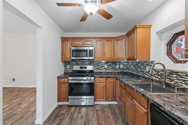 a kitchen with stainless steel appliances granite countertop a stove and a sink