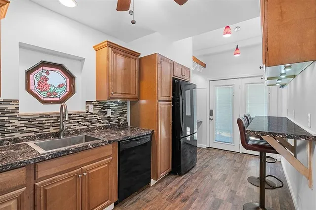 a kitchen with stainless steel appliances granite countertop a refrigerator and a stove