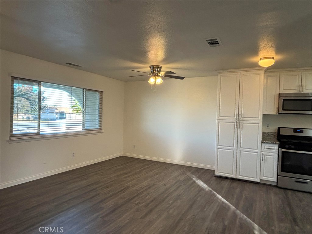 15137 Luna Road Victorville, CA 92392 - Photo 4 of 20 a view of a kitchen with a sink dishwasher and a microwave