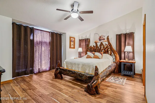 a bedroom with a bed and wooden floor