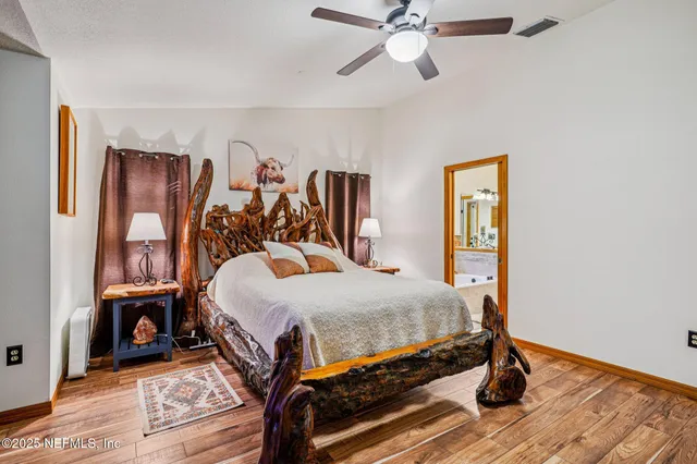 a bedroom with a bed and wooden floor