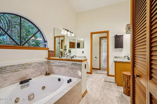 a bathroom with a bathtub sink and mirror