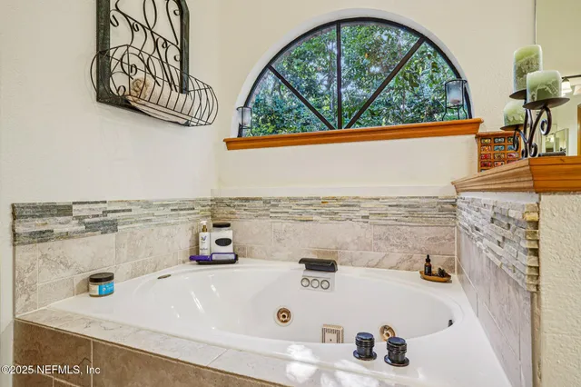 a bathroom with a tub and sink
