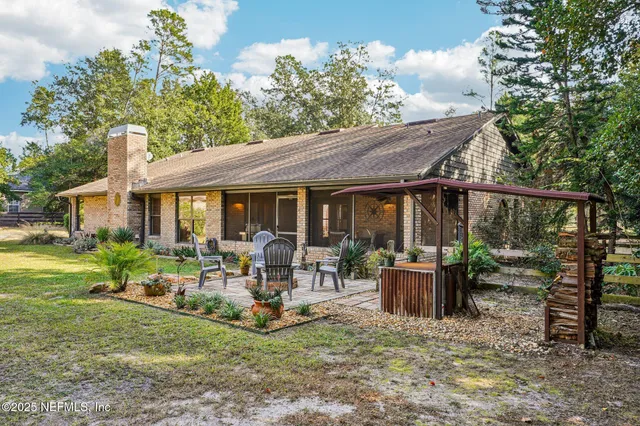 a view of house with backyard outdoor seating and green space