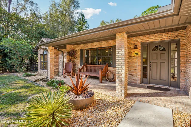 a view of a patio with table and chairs near a barn