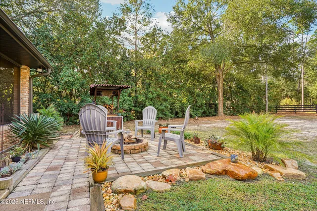 a view of backyard with swimming pool and seating space