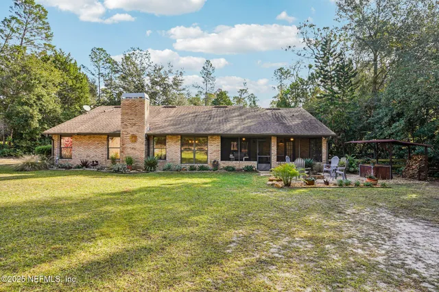 a front view of a house with swimming pool having outdoor seating
