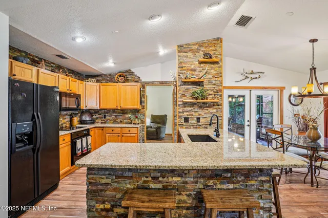 a kitchen with stainless steel appliances granite countertop a stove and a refrigerator