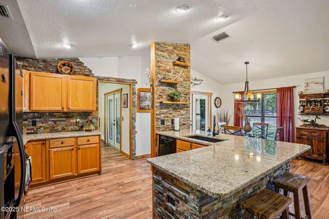 a kitchen with stainless steel appliances granite countertop a stove and refrigerator