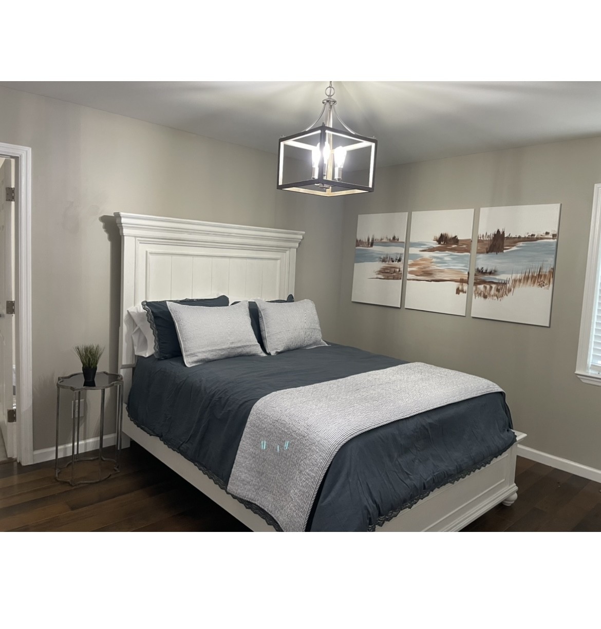 310 Shasteen Ridge Road Lynchburg, TN 37352 - Photo 19 of 36 a bedroom with a bed and a chandelier