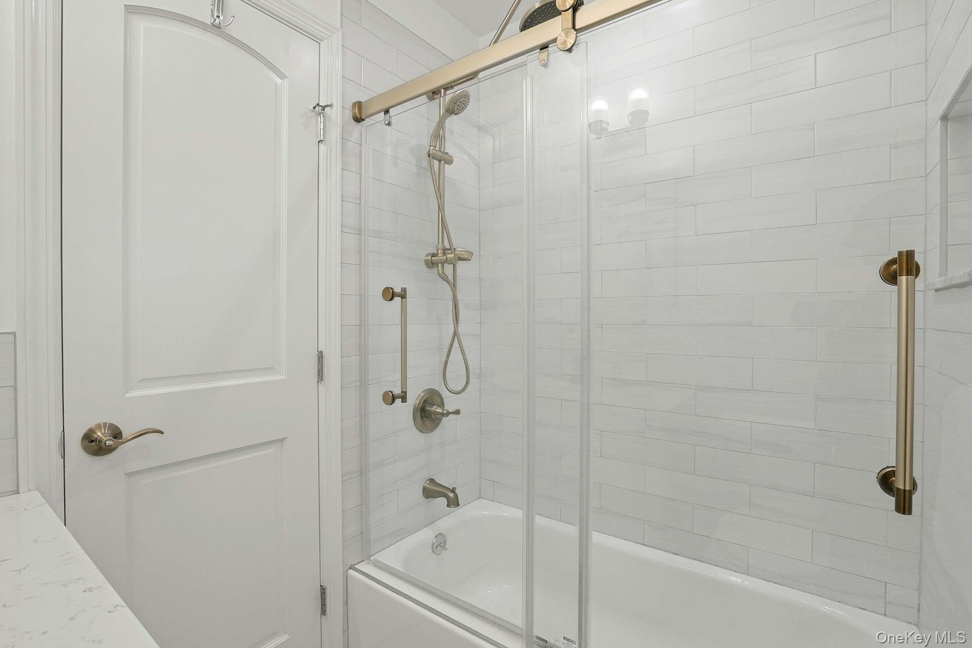 1245 California Road, Unit B23 Eastchester, NY 10709 - Photo 12 of 21 a bathroom with a bathtub and a shower