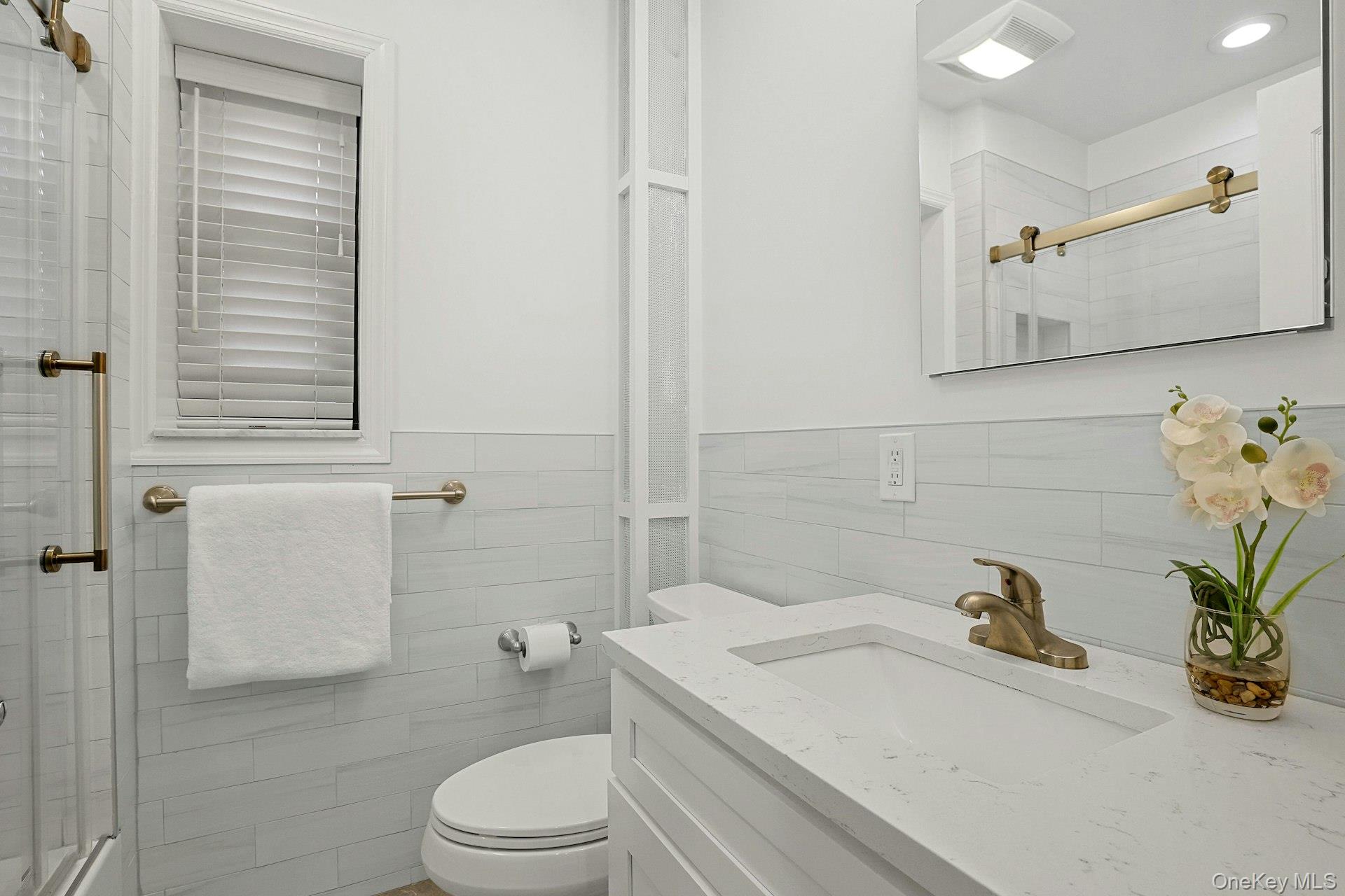 1245 California Road, Unit B23 Eastchester, NY 10709 - Photo 13 of 21 a bathroom with a sink a toilet and shower