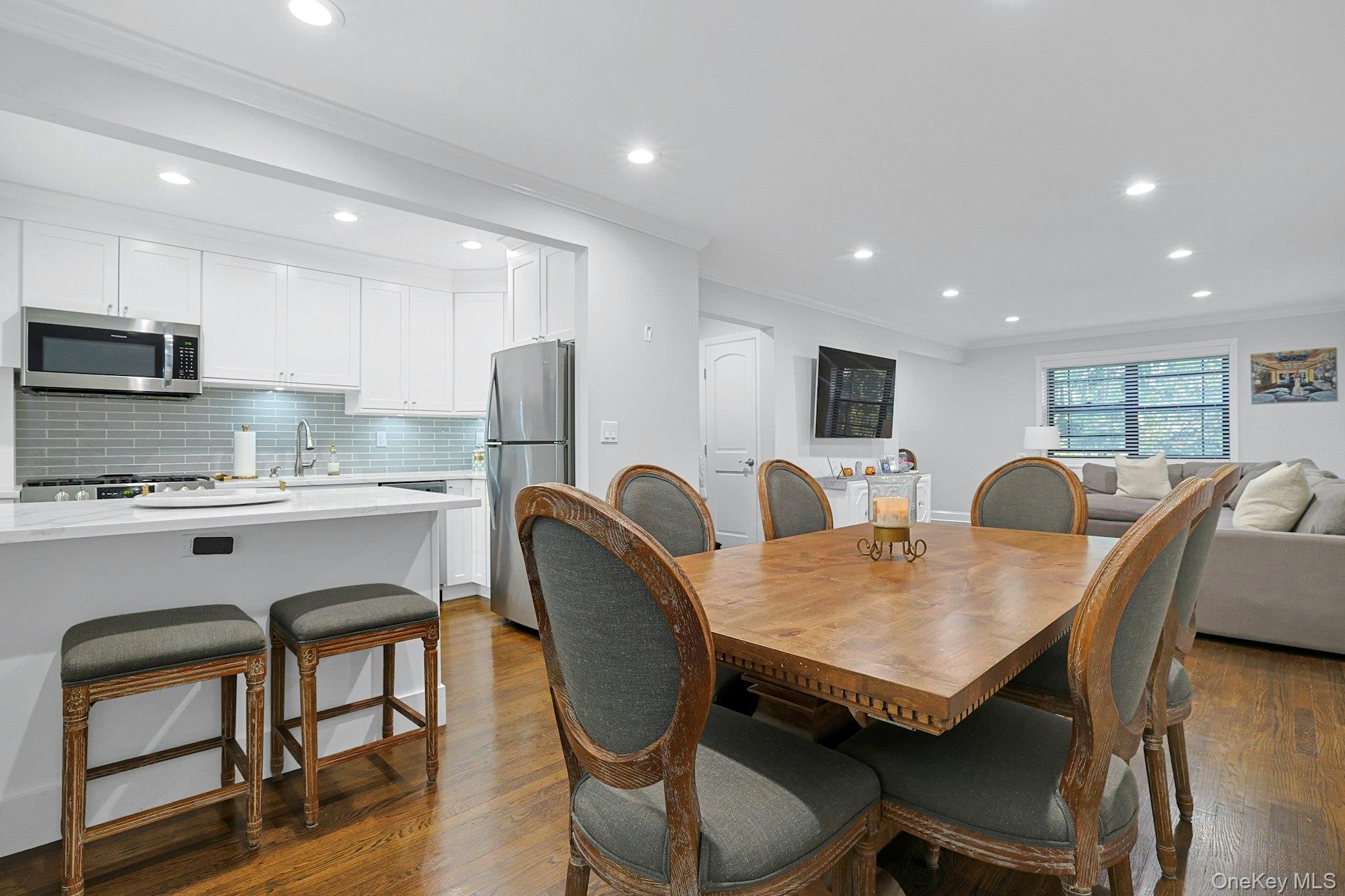 1245 California Road, Unit B23 Eastchester, NY 10709 - Photo 8 of 21 a view of a dining room with furniture and wooden floor