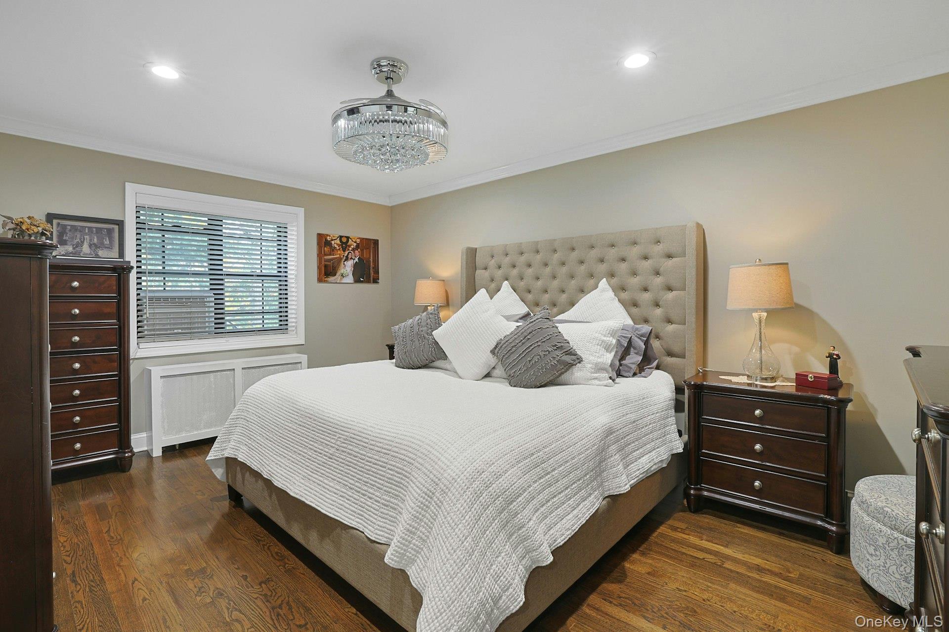 1245 California Road, Unit B23 Eastchester, NY 10709 - Photo 10 of 21 a bedroom with a bed and a chandelier