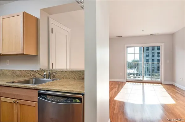 a view of a kitchen with a sink and a window