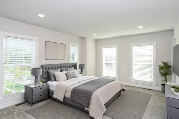 a bedroom with a large bed and a large window