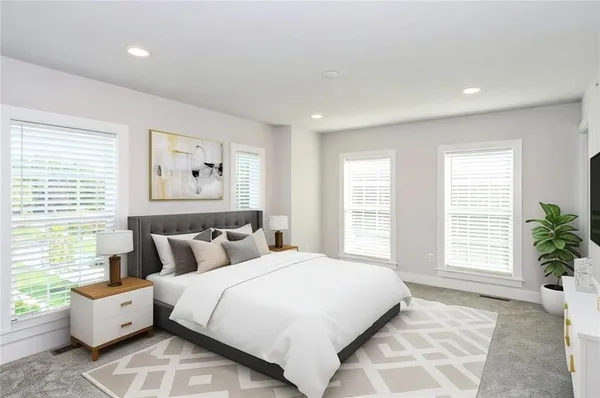 a bedroom with bed and a large window